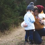 woman-with-brown-baby-carrier-and-little-kid-in-white-jacket-701014